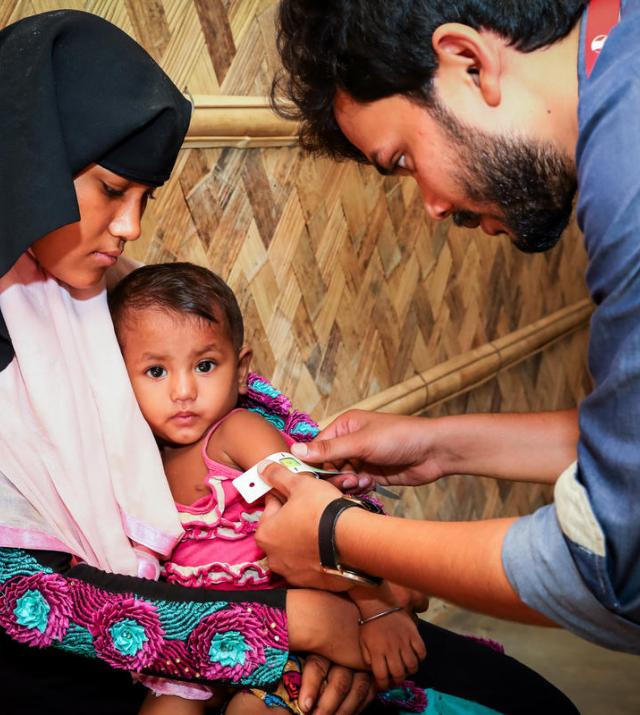 a photo of a doctor inspecting a child