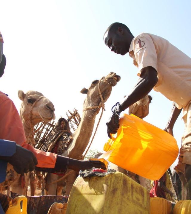 Photo of people fetching water