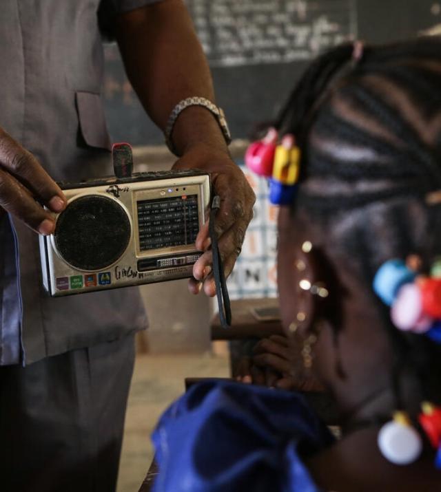 photo of a man holding a radio