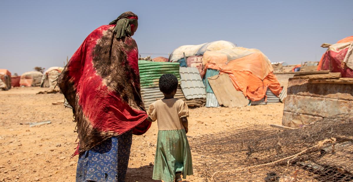 Two people turned away from the camera in Somalia, who have been displaced by the drought